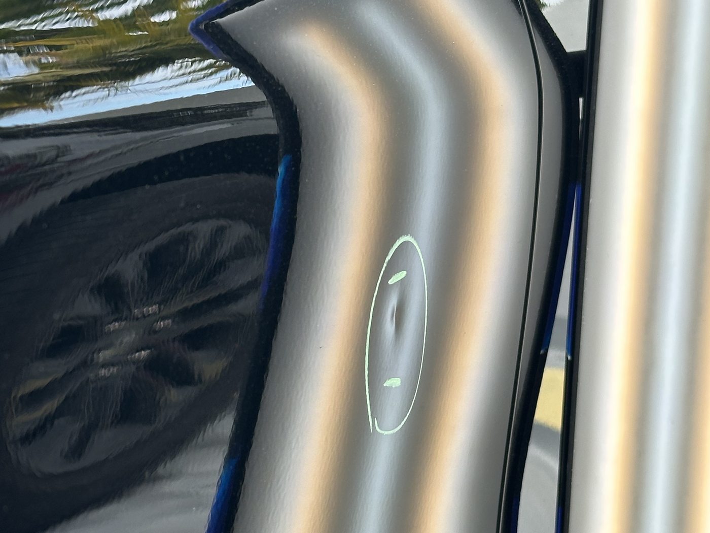 Before paintless dent repair — visible dent in panel