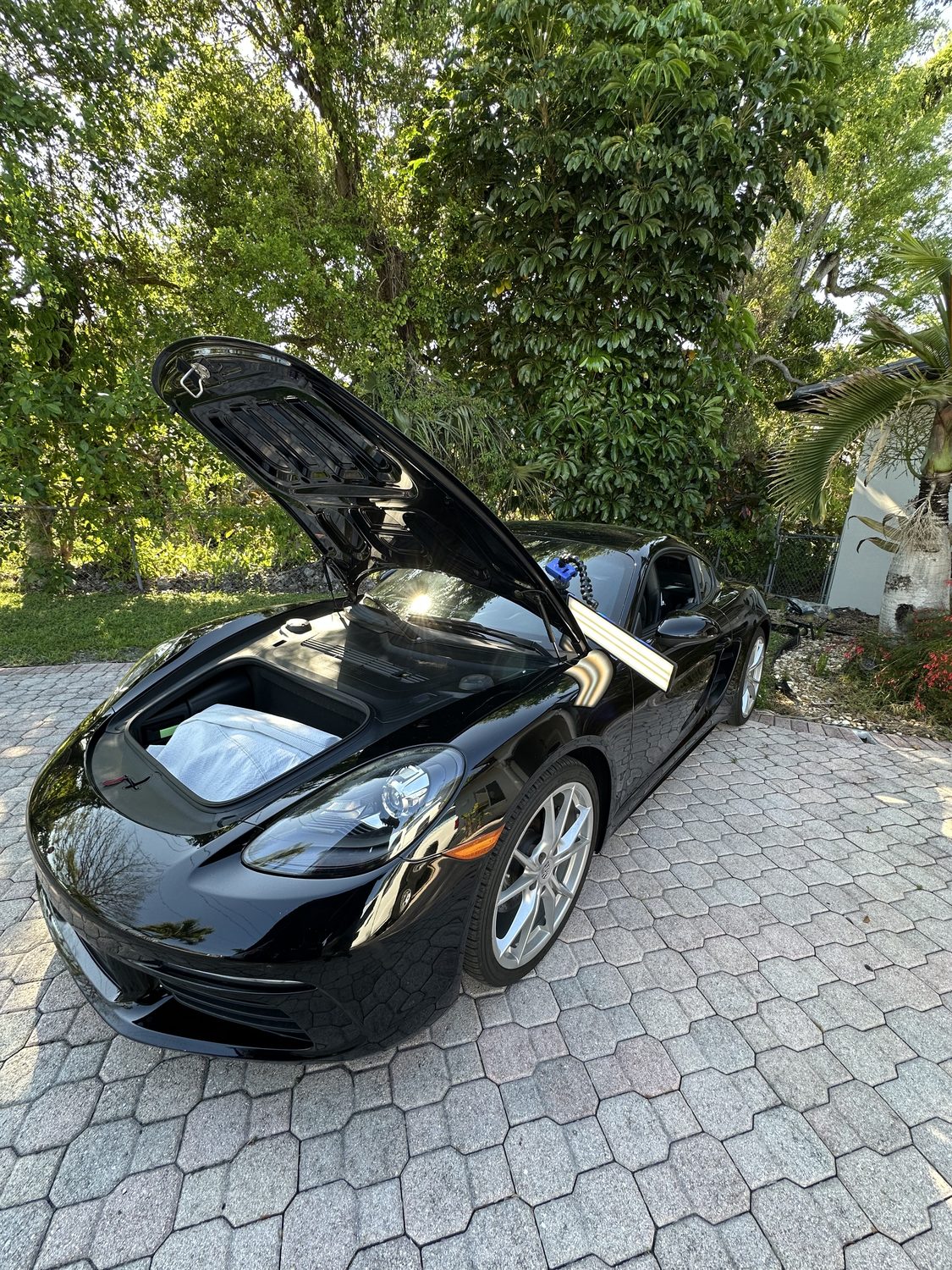 Paintless dent repair on a black sports coupe, Miami