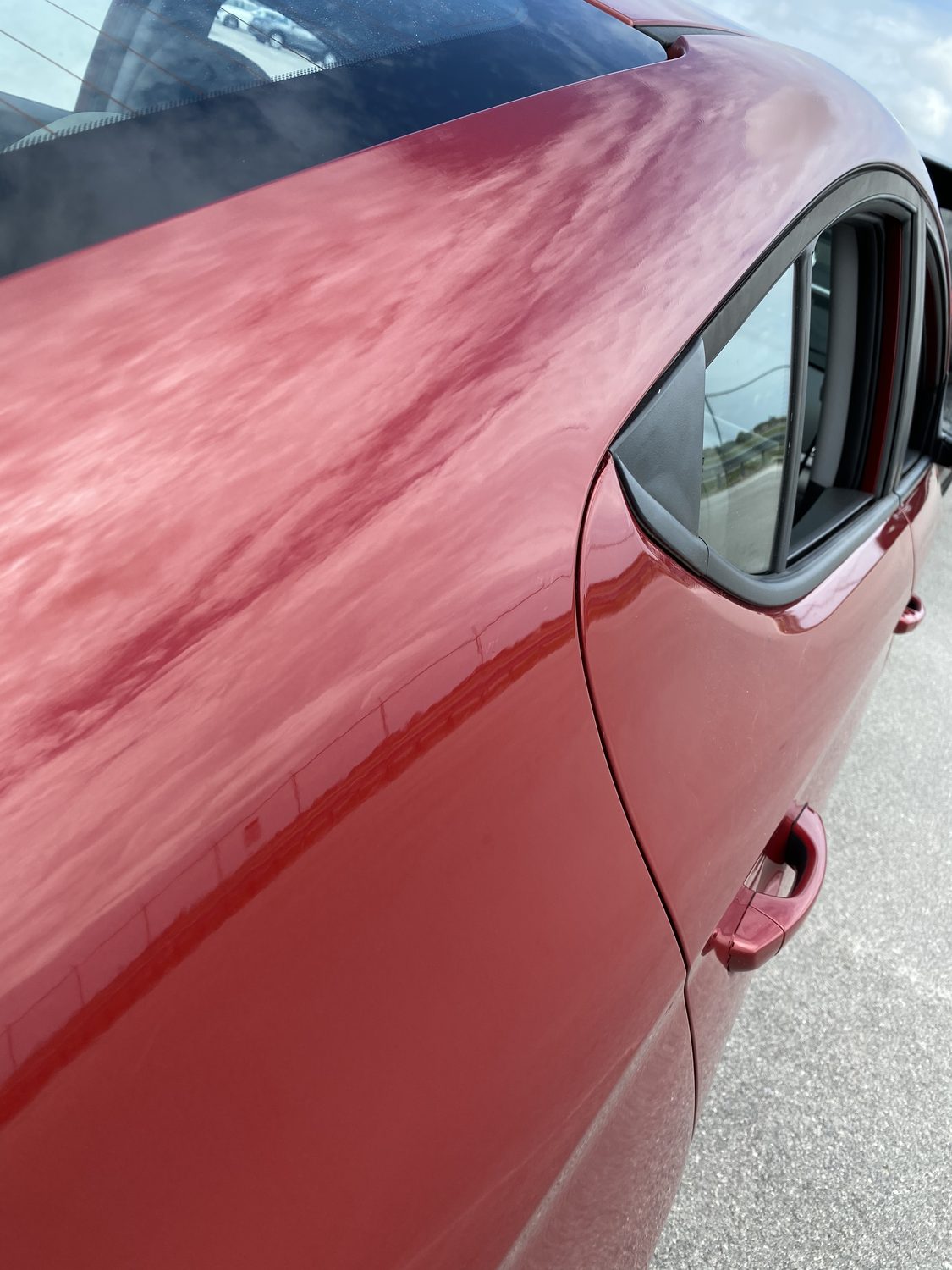 Maroon panel after paintless dent repair — dent removed cleanly, Miami
