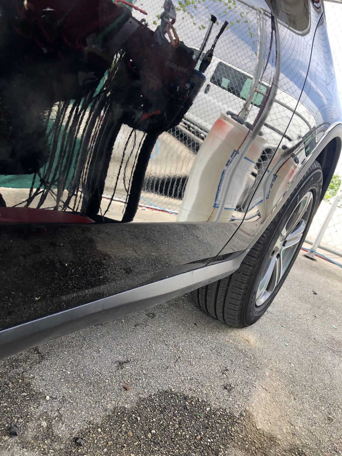 Black panel after paintless dent repair — smooth, factory paint intact, Miami