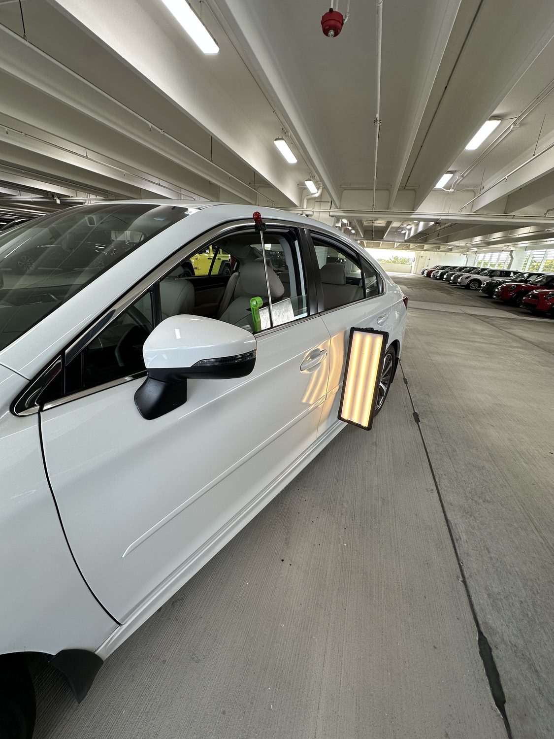 Paintless dent repair in progress on a white panel, Miami