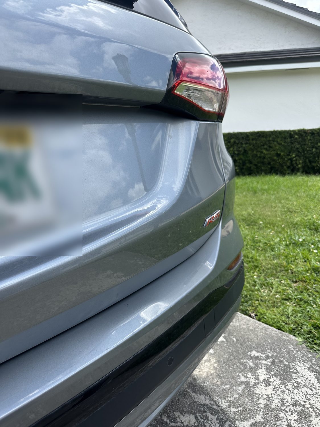 Dent on a quarter panel from a minor collision before paintless dent repair, Miami