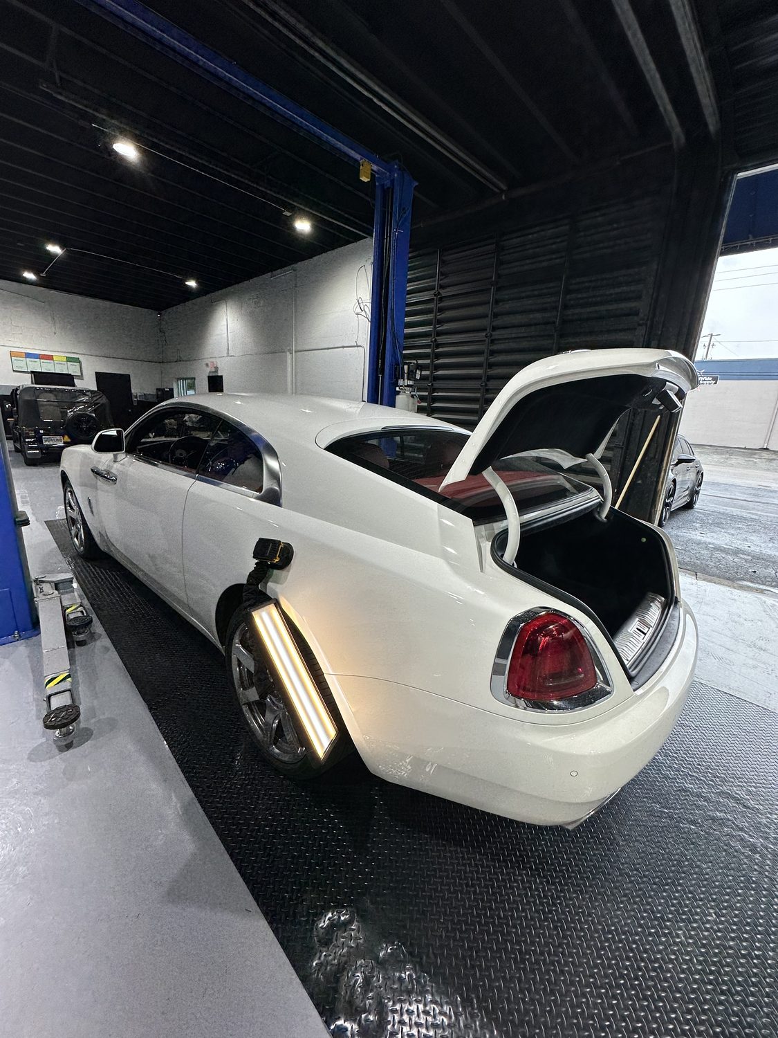 Paintless dent repair on a luxury sedan, Miami
