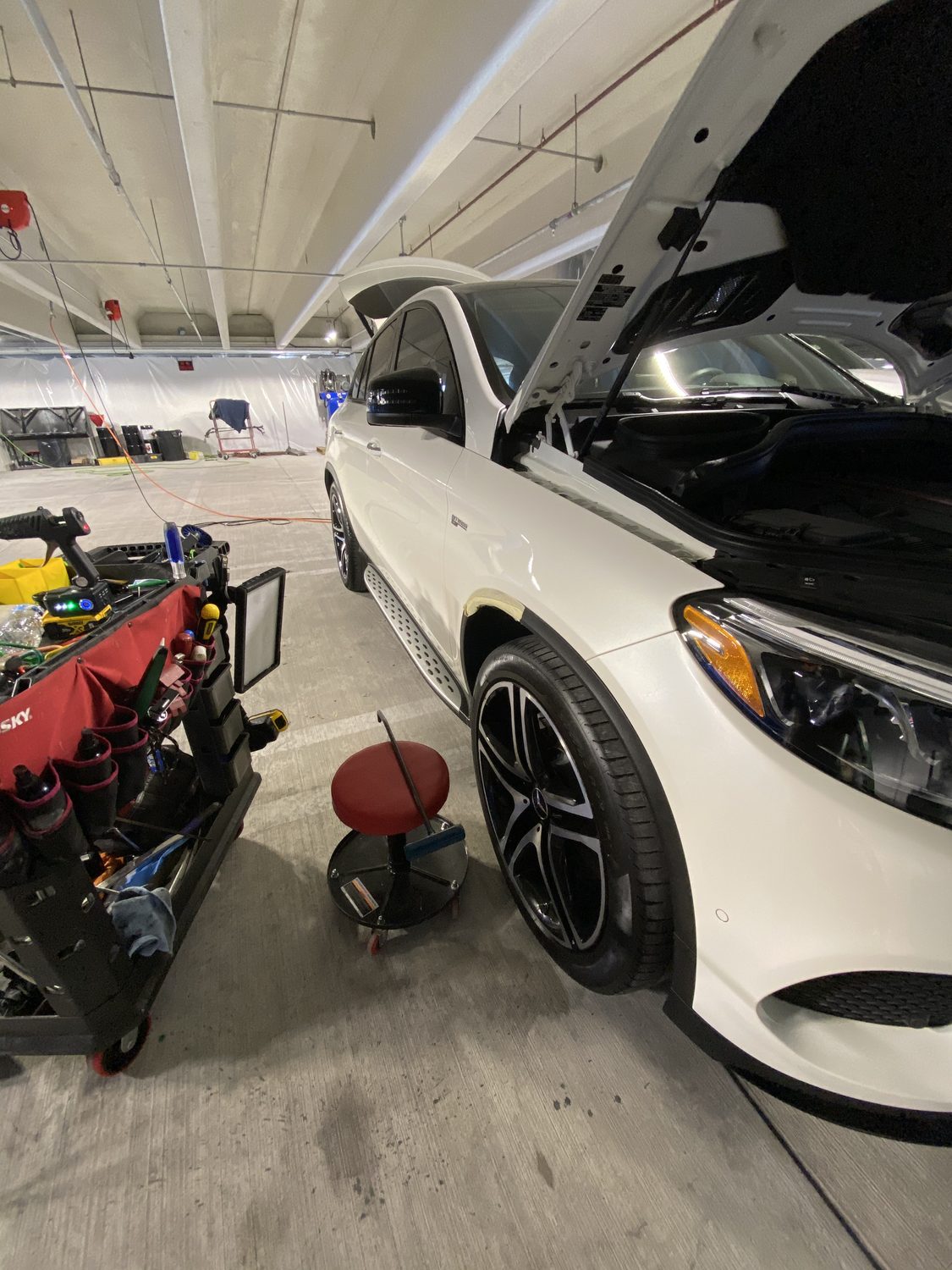 White Mercedes in the shop for paintless dent repair, Miami