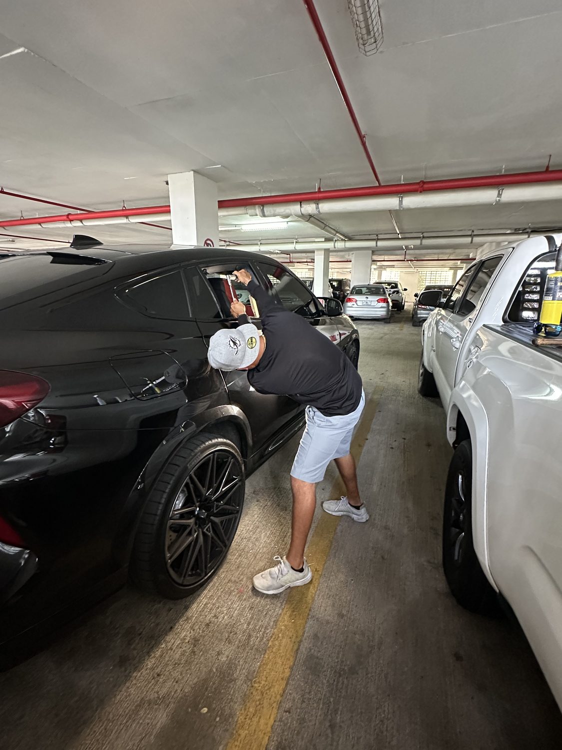 Technician performing paintless dent repair by hand, Miami