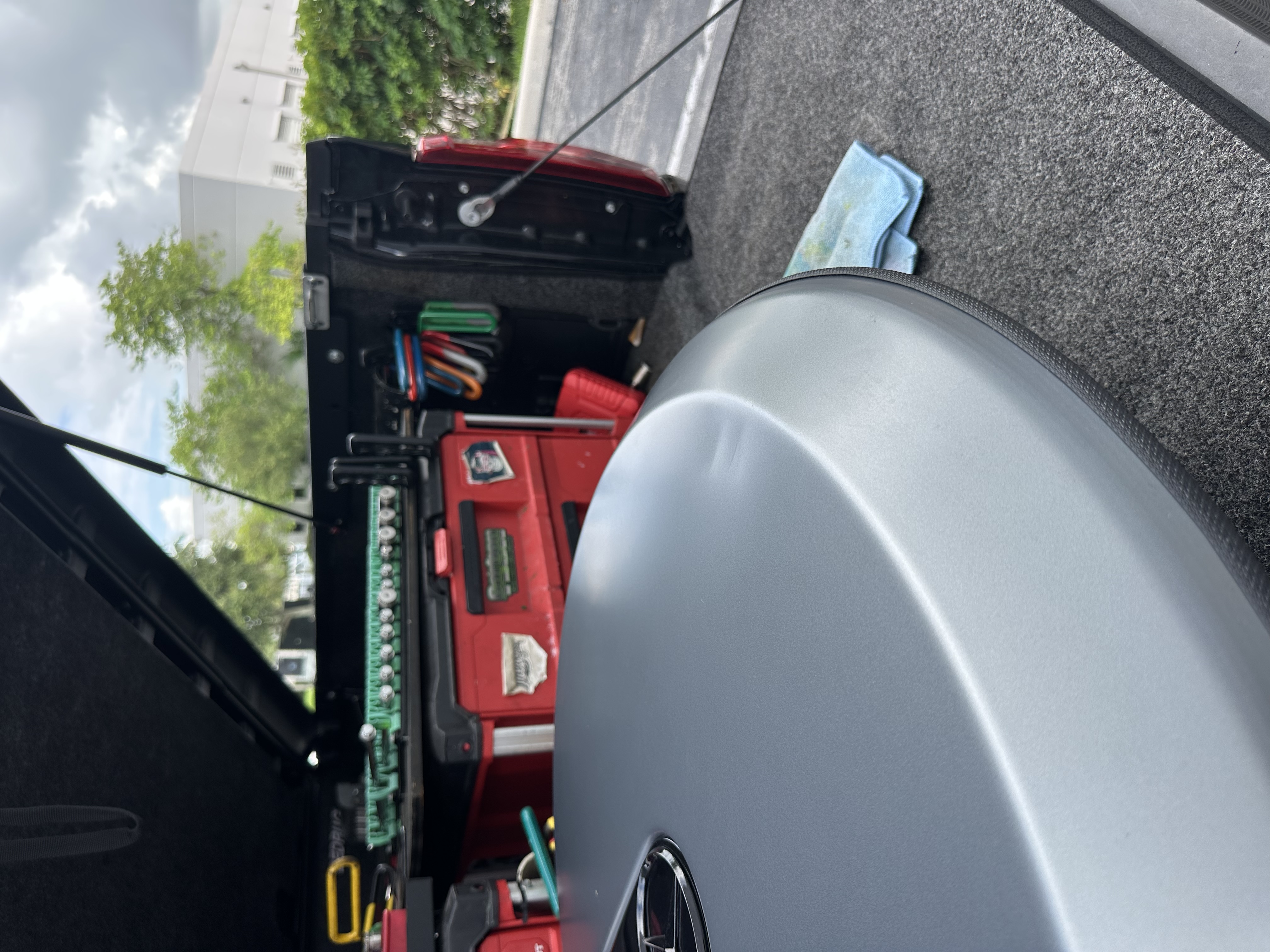 Dent on a silver Mercedes trunk lid before paintless dent repair, Miami