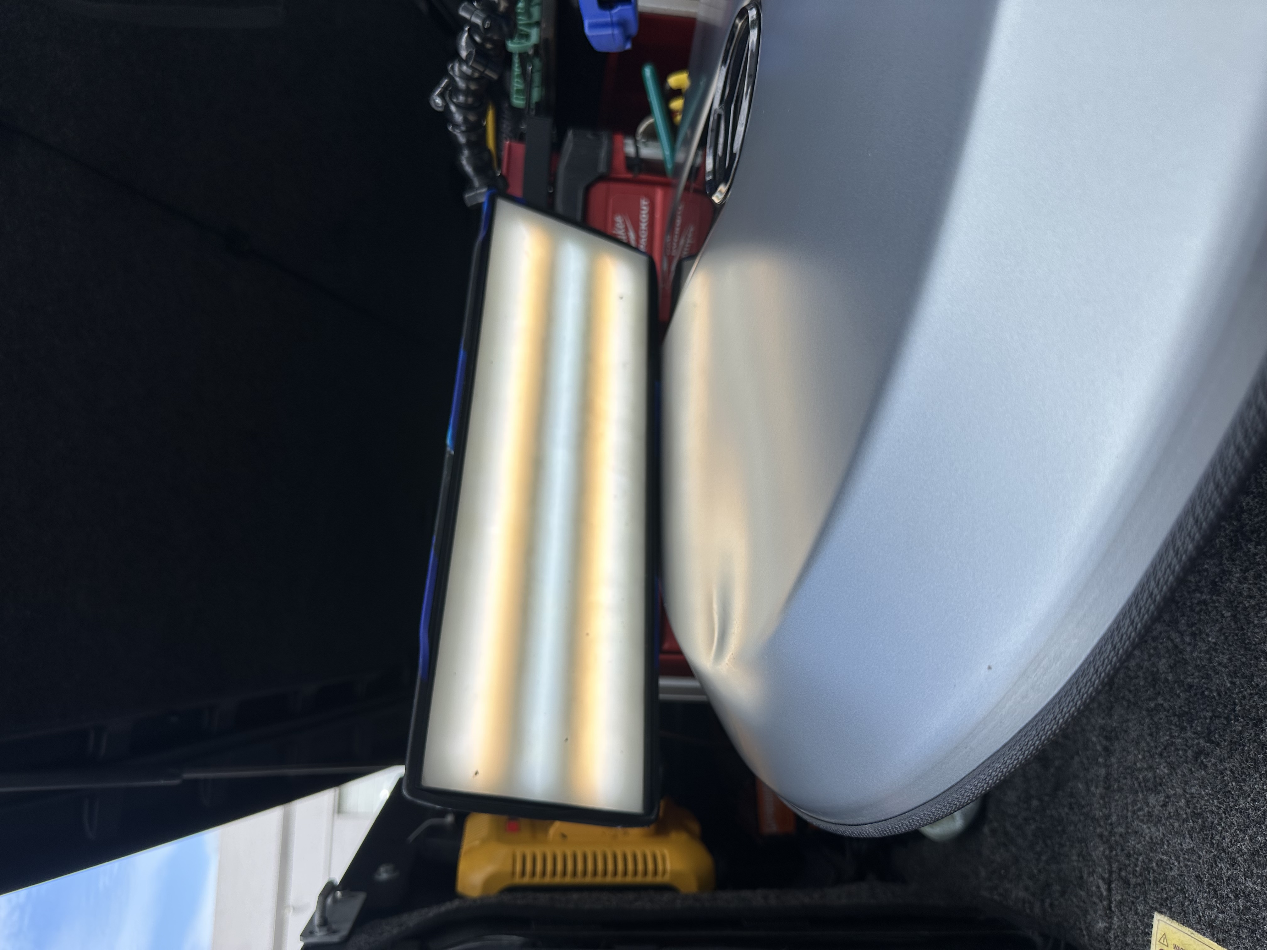 PDR reflection board on a silver Mercedes trunk lid showing dent detail, Miami