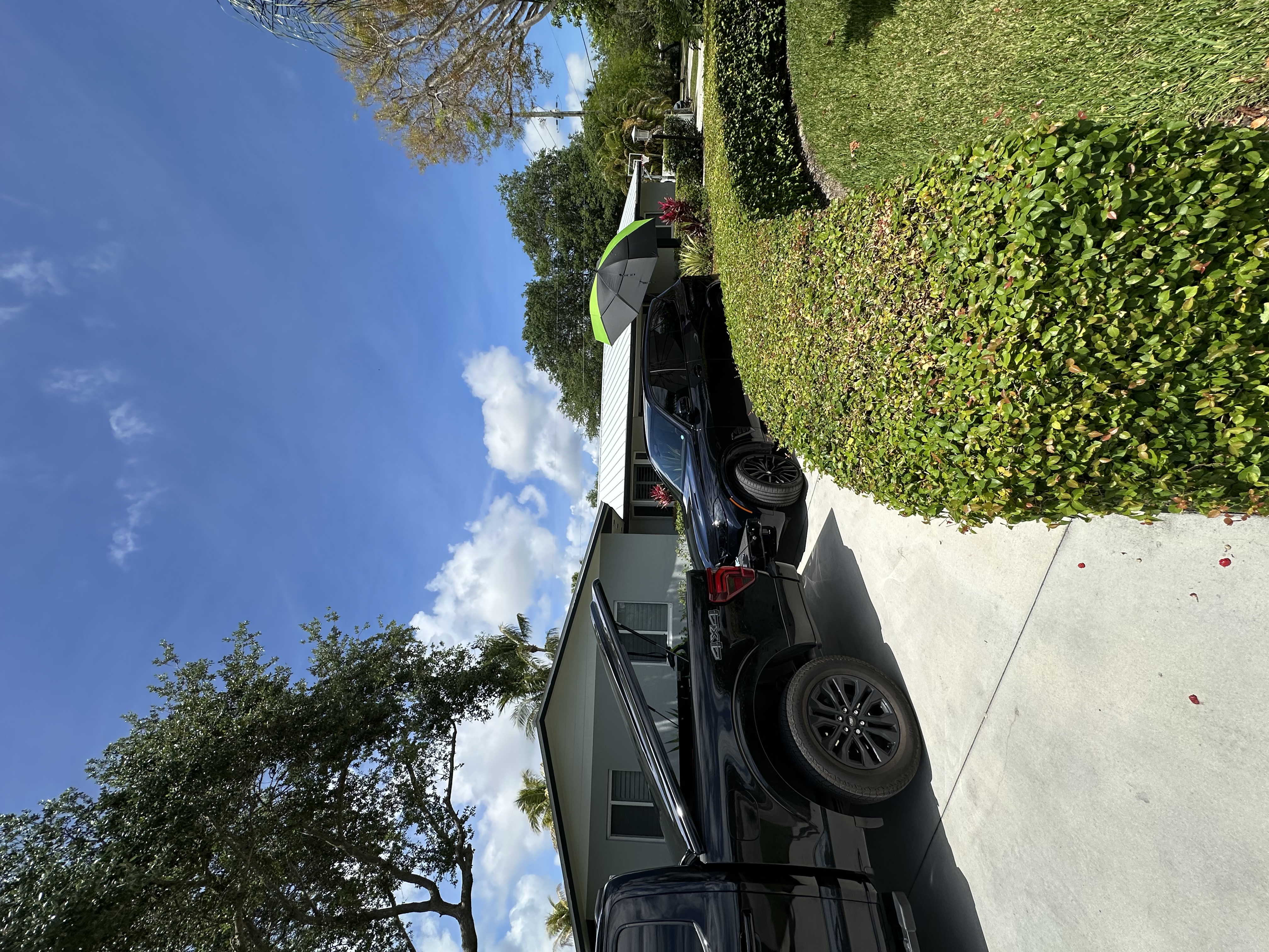 Mobile paintless dent repair setup at a residential driveway, Miami