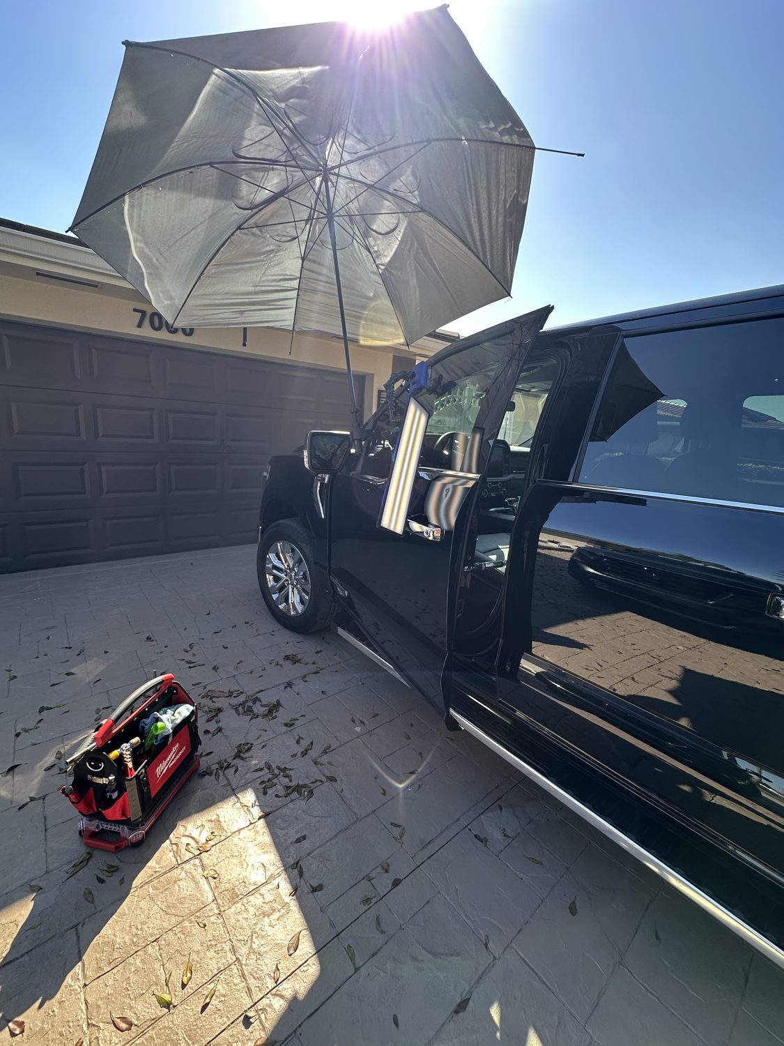 Mobile paintless dent repair setup at a driveway, Miami